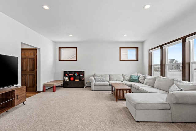 living area featuring recessed lighting and light colored carpet