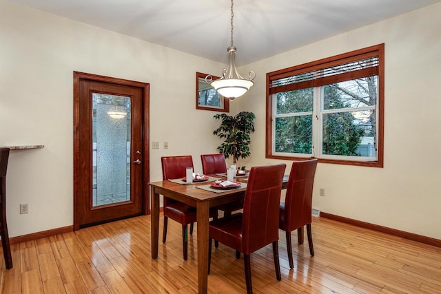 dining room with light wood-type flooring and baseboards