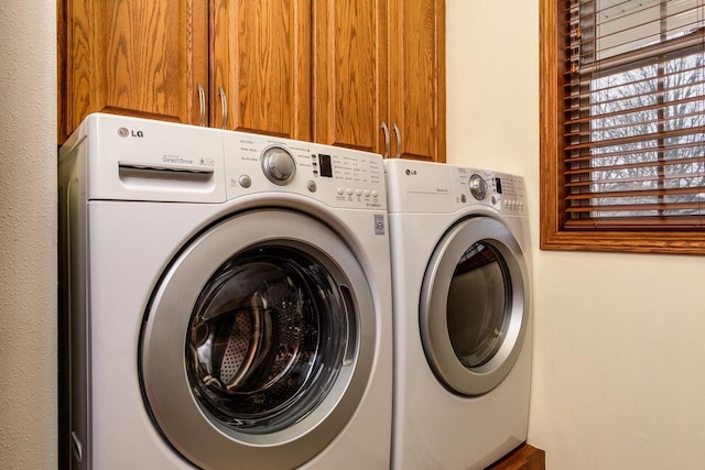 washroom with independent washer and dryer and cabinet space