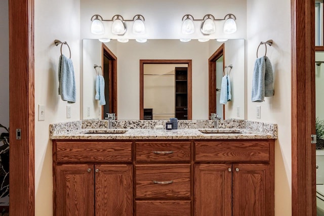 bathroom featuring a sink and double vanity