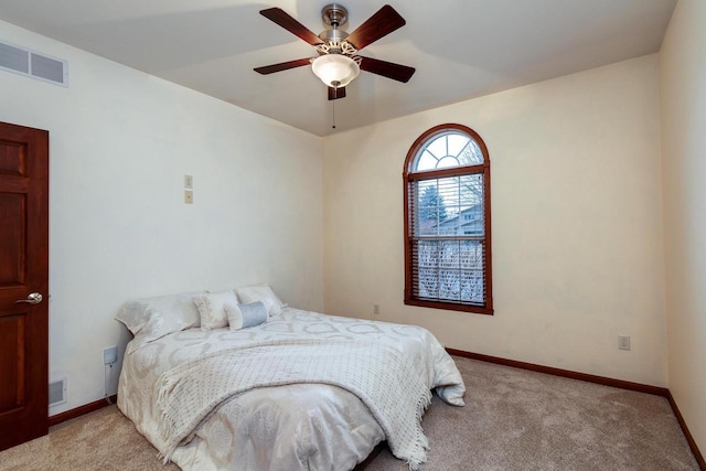 bedroom featuring carpet floors, visible vents, and baseboards