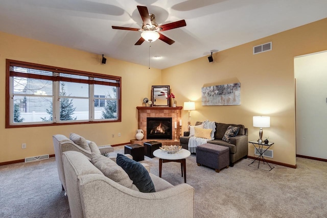 carpeted living area with visible vents, a fireplace, and baseboards