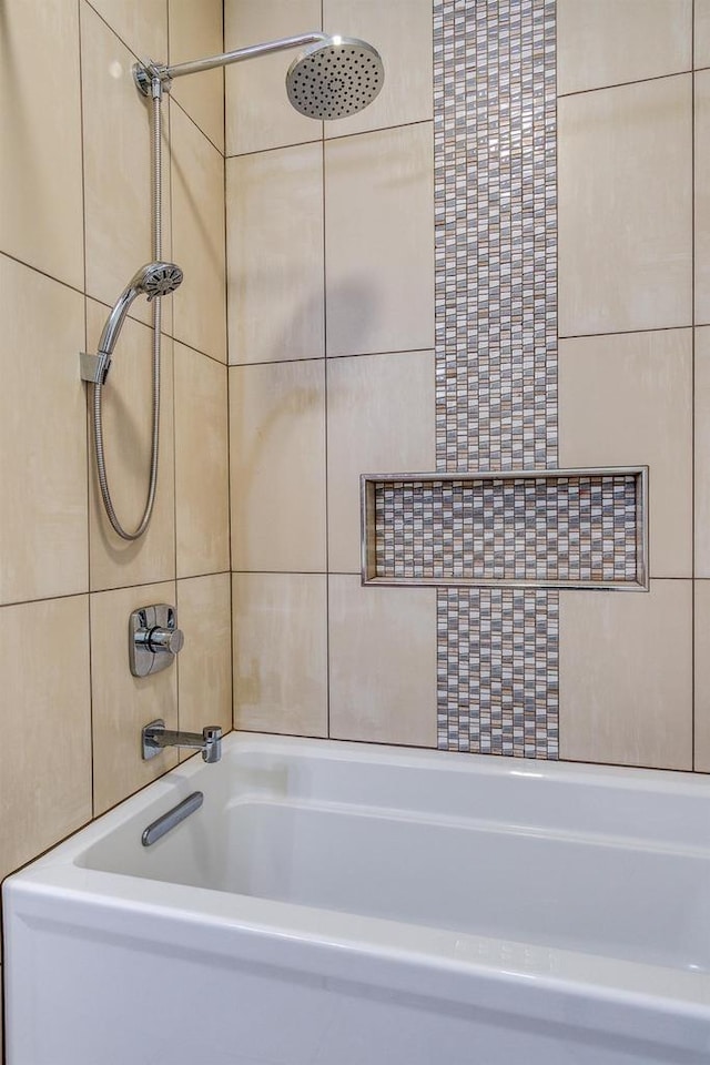 full bath with bathing tub / shower combination and tile walls