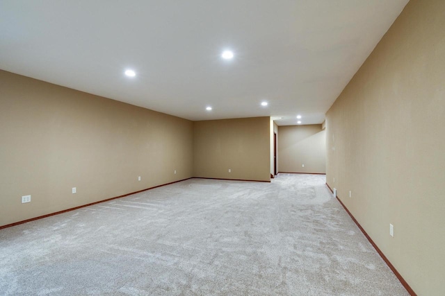 unfurnished room featuring baseboards, light colored carpet, and recessed lighting