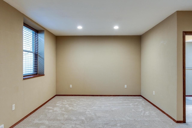 spare room with carpet floors, recessed lighting, and baseboards