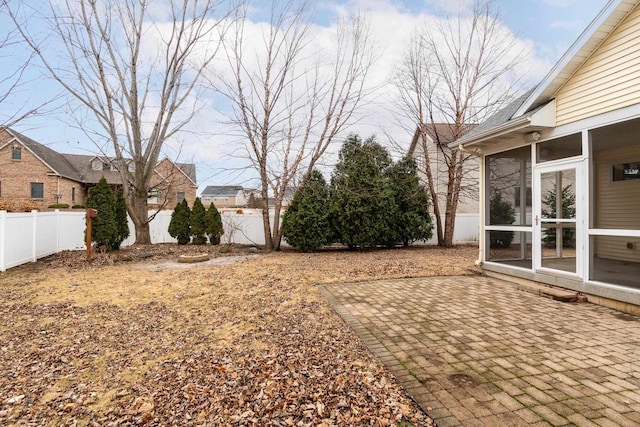 view of yard with fence private yard, a sunroom, and a patio