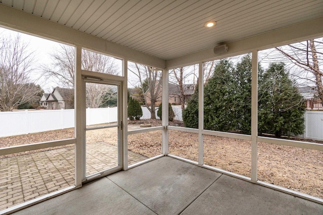 unfurnished sunroom featuring wood ceiling and plenty of natural light