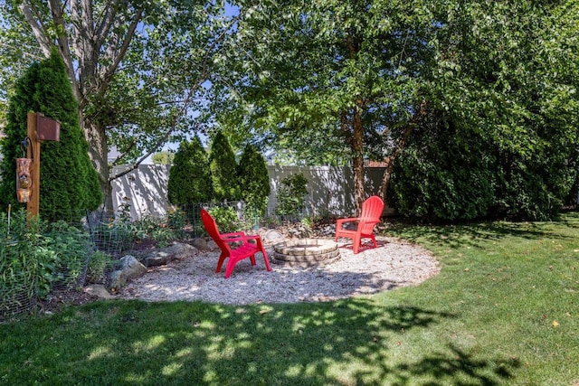 view of yard with an outdoor fire pit and fence