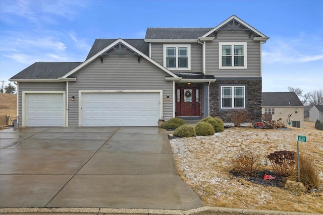 view of front facade featuring stone siding, an attached garage, and concrete driveway