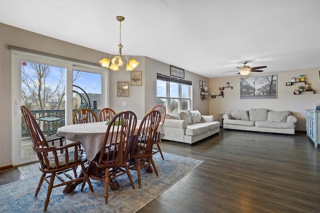 dining room with dark wood finished floors, baseboards, and ceiling fan with notable chandelier