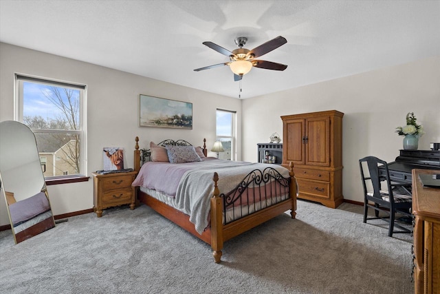 bedroom with ceiling fan, baseboards, and light colored carpet