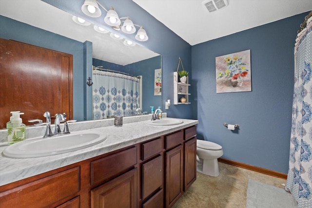 bathroom featuring baseboards, visible vents, a sink, and toilet