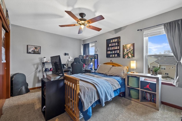 bedroom featuring multiple windows, carpet, a ceiling fan, and baseboards