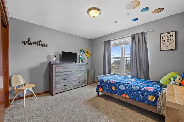 carpeted bedroom with baseboards