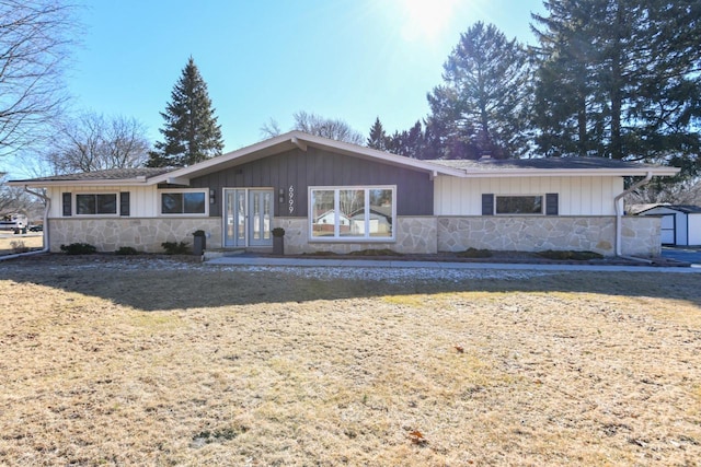 single story home featuring stone siding