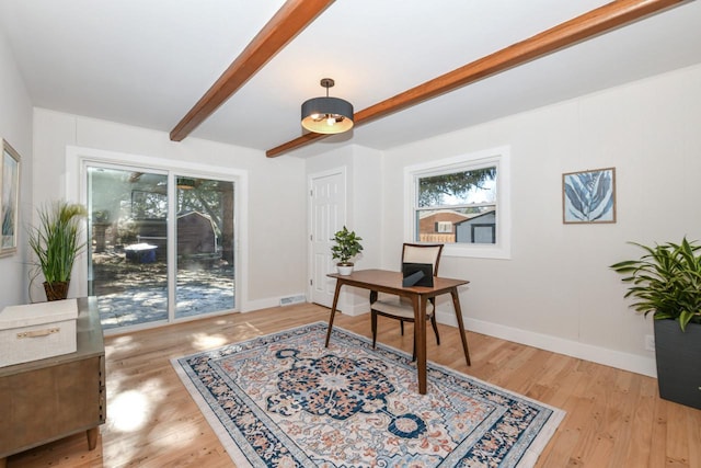 office area featuring visible vents, wood finished floors, beam ceiling, and baseboards