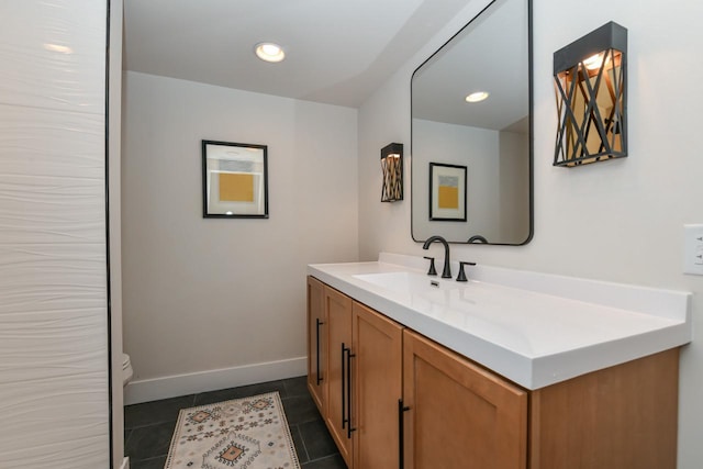 bathroom with recessed lighting, toilet, vanity, tile patterned flooring, and baseboards