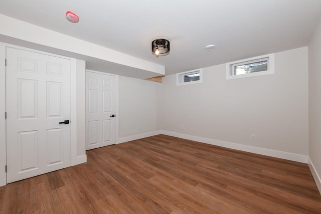 empty room featuring wood finished floors and baseboards