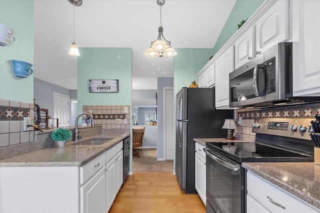 kitchen with white cabinetry, appliances with stainless steel finishes, decorative backsplash, and a sink