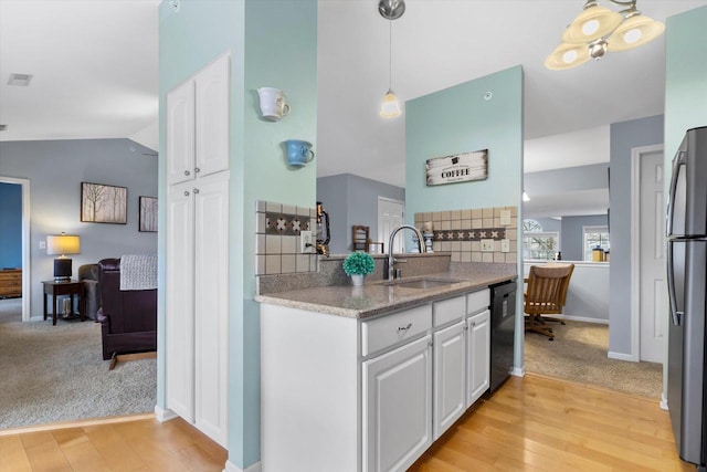 kitchen with freestanding refrigerator, white cabinetry, a sink, and dishwasher