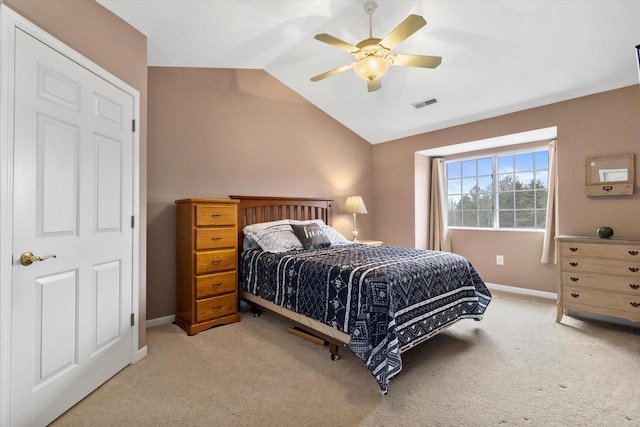 bedroom with baseboards, visible vents, vaulted ceiling, and light colored carpet