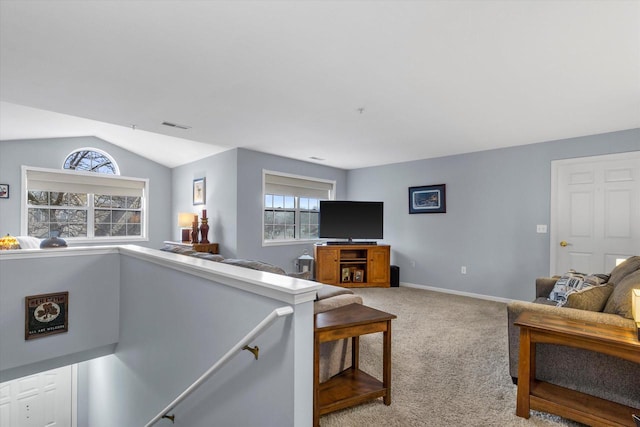 living room with light carpet, baseboards, visible vents, and vaulted ceiling