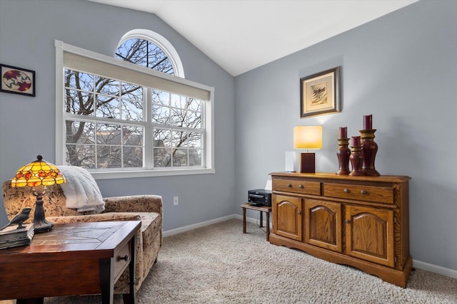 living area with light carpet, baseboards, and vaulted ceiling