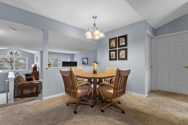 carpeted dining area featuring lofted ceiling, a notable chandelier, and baseboards