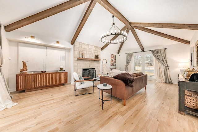 living area featuring light wood finished floors, baseboards, vaulted ceiling with beams, an inviting chandelier, and a fireplace