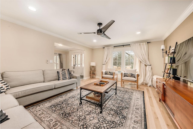 living room featuring ceiling fan, ornamental molding, recessed lighting, and light wood-style floors