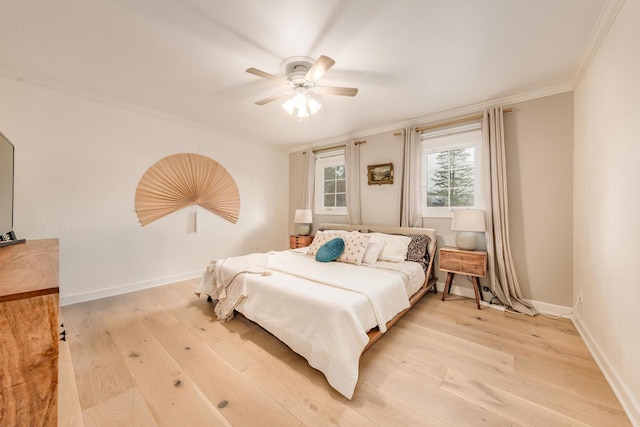 bedroom with light wood-style floors, baseboards, ornamental molding, and a ceiling fan