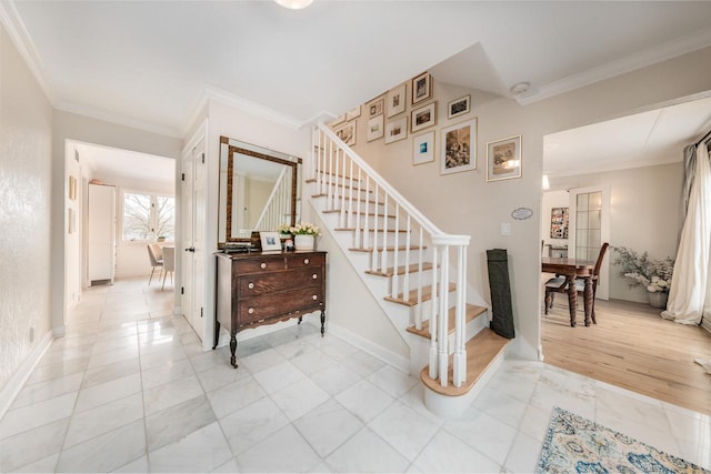 stairway with ornamental molding and baseboards