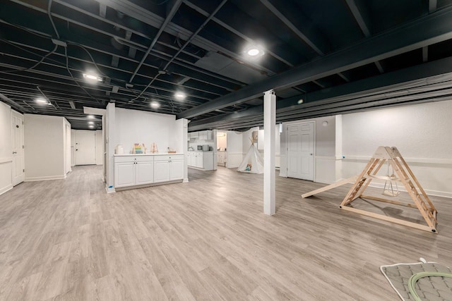 finished basement featuring light wood-style flooring