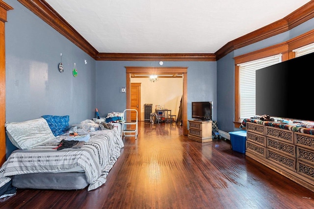 living area with crown molding and wood finished floors