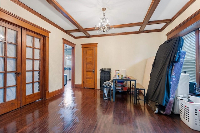 interior space with baseboards, coffered ceiling, wood finished floors, and french doors