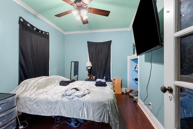 bedroom featuring baseboards, a ceiling fan, crown molding, and wood finished floors