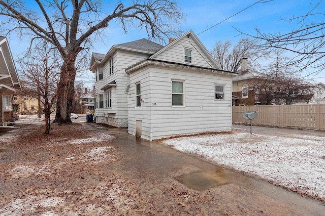 view of home's exterior featuring fence