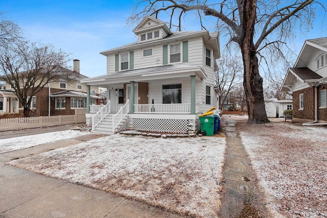 american foursquare style home featuring a porch