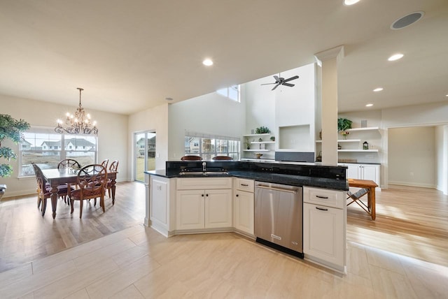 kitchen featuring light wood-type flooring, stainless steel dishwasher, white cabinetry, a sink, and ceiling fan with notable chandelier