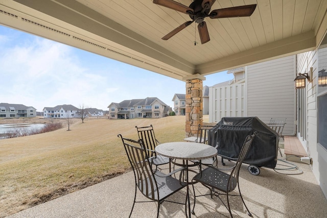 view of patio with outdoor dining area, a residential view, grilling area, and a ceiling fan