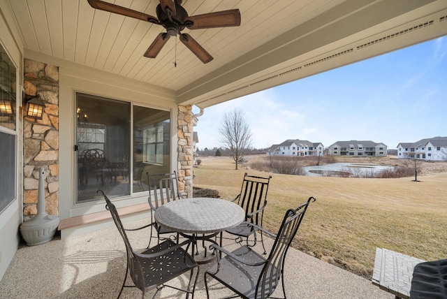 view of patio / terrace with ceiling fan and a residential view