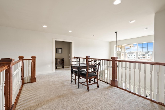 dining space with baseboards, recessed lighting, and light colored carpet