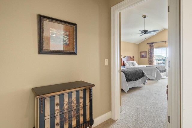 carpeted bedroom featuring lofted ceiling, baseboards, and a ceiling fan