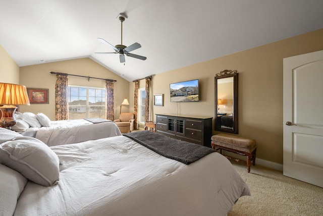 carpeted bedroom featuring vaulted ceiling, a ceiling fan, and baseboards