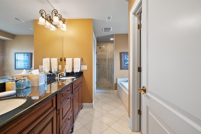 full bathroom featuring tile patterned flooring, visible vents, a sink, and a shower stall