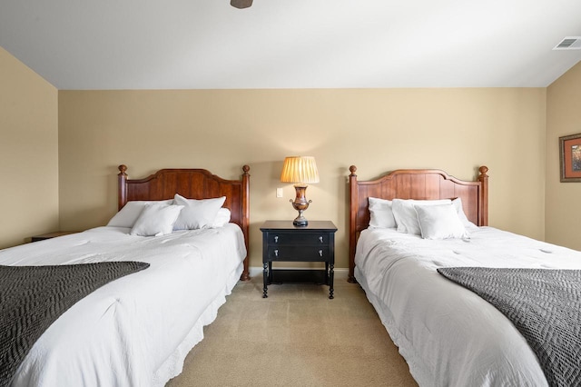 bedroom featuring light colored carpet, visible vents, and baseboards