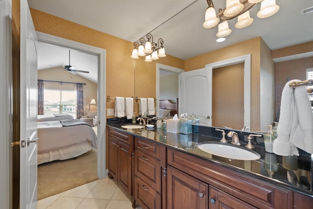 ensuite bathroom with a sink, connected bathroom, and wallpapered walls