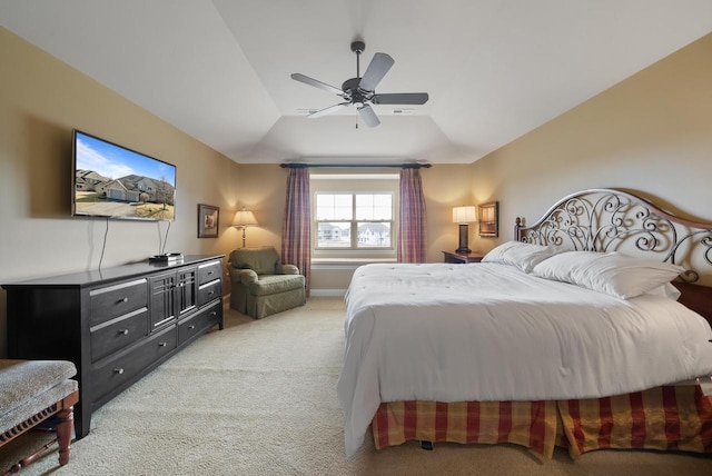 bedroom with lofted ceiling, baseboards, a ceiling fan, and light colored carpet