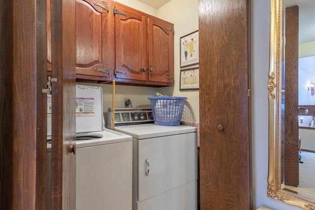 laundry area with cabinet space and washer and clothes dryer