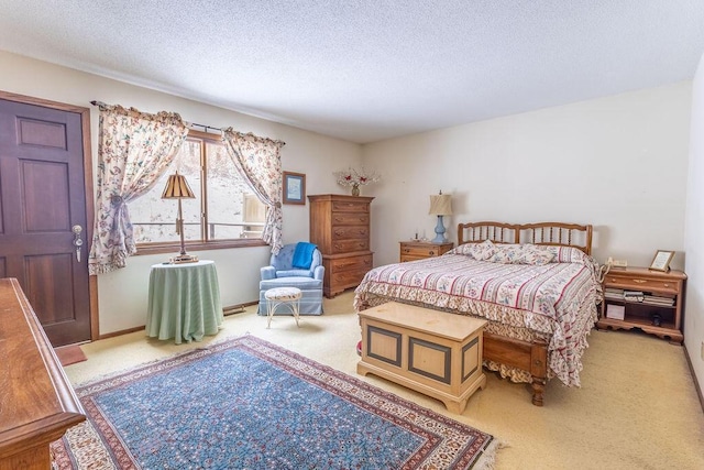 carpeted bedroom featuring a textured ceiling and baseboards